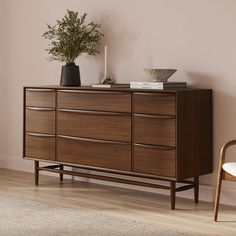 a wooden dresser sitting on top of a hard wood floor