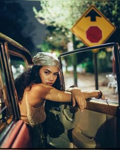 a woman leaning out the window of a car