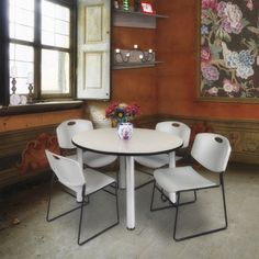 a white table with four chairs around it