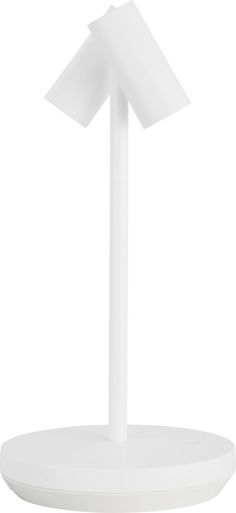 a white table lamp on top of a round base with an arrow shaped light in the middle