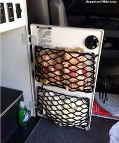 a refrigerator with some food in it on the back of an airplane or plane seat