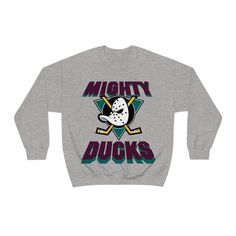 Flash back in time with this classic Anaheim Ducks throwback sweatshirt! Mighty Ducks Blanket, Throwback Logo Print Sweatshirt For Fall, Fall Throwback Logo Print Sweatshirt, Pre-shrunk Cotton Throwback Sweatshirt, Throwback Fan Merchandise Cotton Sweatshirt, Throwback Cotton Sweatshirt For Fan Merchandise, Throwback Sweatshirt With Logo Print For Sports Season, Winter Fan Apparel Sweatshirt With Graphic Print, Throwback Logo Print Sweatshirt For Sports Season