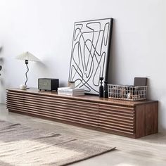 a living room with white walls and wooden furniture