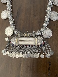 "Here is an amazing, original necklace from Oman. It measures approximately 37 3/4\" (95,8 cm) long. The main pendant measures 4 5/8\" (11,75 cm) long and ~ 5 3/4\" (14,6 cm) wide. This is wonderful vintage piece, in great shape commensurate with age and tribal use. It features gorgeous workmanship. It is strung on its original cotton cording. The darker material on the loop side is from incense, often applied to jewelry from this region. This piece is truly massive and weighs in at just over 71 Traditional One-of-a-kind Necklace For Festival, One-of-a-kind Medallion Necklace For Festivals, Unique Festival Necklace With Coin Pendant, Festival Coin Pendant Necklace, Vintage White Jewelry For Ceremonial Occasions, Bohemian Medallion Necklace From Vintage Collection, Traditional Medallion Jewelry For Ceremonial Occasions, Traditional One-of-a-kind Necklaces For Ceremonial Occasions, Traditional One Of A Kind Necklaces For Ceremonial Occasions