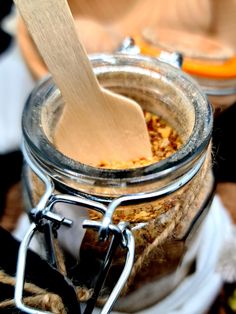 a wooden spoon sticking out of a jar filled with food