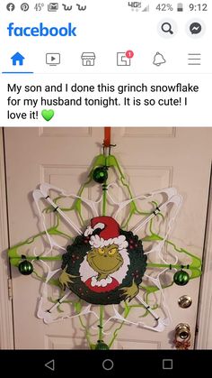 the grinch snowflake is hanging on the front door, and it's so cute