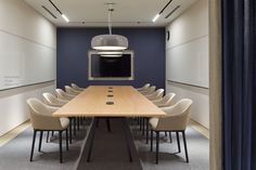 an empty conference room with chairs and a long table