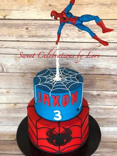 a spiderman birthday cake on top of a table