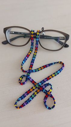 "You can always wear it easily.  You can use it not only as eyeglass chain, but also as a necklace and bracelet with rainbow colors.  Measures approx. 28\" (71 cm) total length Rainbow sunglasses necklace will be a perfect gift for yourself and your loved ones.  The price is for 1 piece of eyeglass necklace with black background. I can make it in any color you want. Please contact me. Thank you for visiting my store." Multicolor Beaded Glasses Chains As Fashion Accessory, Multicolor Beaded Glasses Chains For Fashion Accessory, Multicolor Beaded Glasses Chain, Multicolor Beaded Chain Glasses Chains For Gifts, Multicolor Beaded Glasses Chain As Gift, Multicolor Beaded Glasses Chain For Gift, Multicolor Beaded Glasses Chains For Festival, Adjustable Beaded Multicolor Glasses Chains, Multicolor Adjustable Glasses Chains For Gift