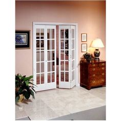 an open door leading to a living room with pink walls and white trim on the doors