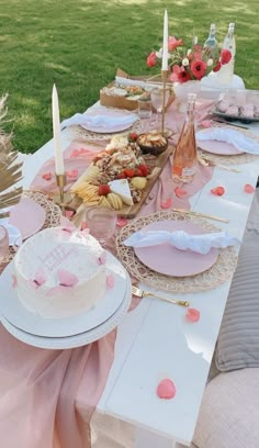 a table topped with a white cake and lots of plates