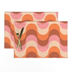 two placemats with forks and spoons on top of each other in an abstract pattern