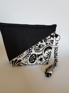 This adorable halloween print wristlet is perfect for any occasion!! It features plenty of storage and a detachable wrist strap! The bag measure 9.5 inches long,6.5 inches high,and 4 inches deep. Black Rectangular Wristlet For Gift, Rectangular Black Wristlet As A Gift, Rectangular Black Wristlet For Gift, Black Wristlet With Zipper Closure For Gift, Black Wristlet With Zipper Closure As Gift, Black Clutch Wristlet For Gift, Black Zipper Pouch Wristlet, Black Pouch Wristlet For Daily Use, Black Rectangular Wristlet With Zipper Pouch