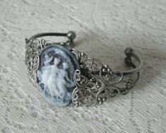 Triple Goddess Cuff Bracelet This beautiful silver plated filigree cuff bracelet has silver plated filigree accents and a triple goddess cameo. Adjustable. Victorian Adjustable Bangle As A Gift, Victorian Adjustable Bangle - Gift, Silver Gothic Cameo Jewelry, Silver Metal Cameo Jewelry, Silver Cameo Bracelet For Gifts, Elegant Silver Bracelet With Cameo, Vintage Silver Cameo Bracelet, Jewelry Magic, Wicca Jewelry