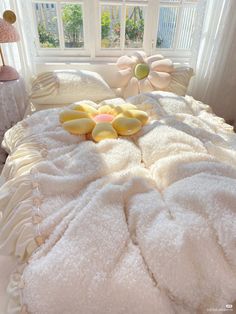 a bed with white sheets and yellow flowers on it