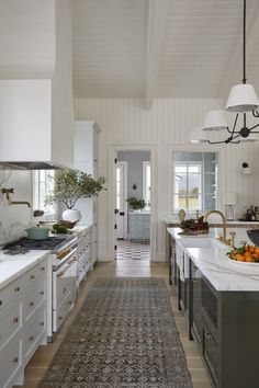 a kitchen with white cabinets and an area rug on the floor that matches the ceiling