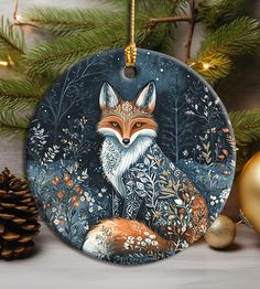 a ceramic ornament with an image of a fox in the woods on it