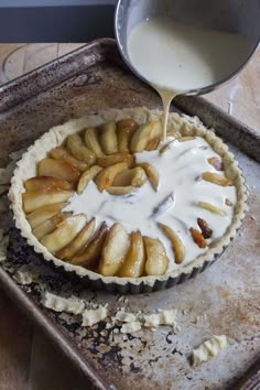 an apple pie is being poured with milk