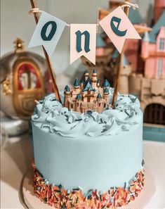 a birthday cake with blue frosting and castle decorations