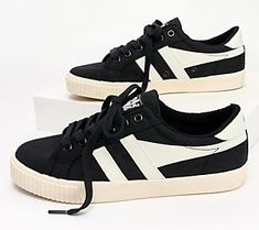 Based on an original style from 1975 that was worn by tennis player, Mark Cox, this ladies' tennis-inspired plimsoll features an  off-white upper, contrasting wing flash, and signature Gola branding. From Gola. Sporty Canvas Shoes With Rubber Waffle Outsoles For Spring, Retro Canvas Shoes With Contrast Sole, Vintage Black Sneakers For Spring, Black Vintage Sneakers For Spring, Retro Low-top Canvas Shoes For Sports, Retro Canvas Shoes With Gum Sole For Sports, Retro Canvas Shoes For Spring Streetwear, Retro Spring Canvas Shoes For Streetwear, Retro Canvas Shoes With Vulcanized Sole For Sports