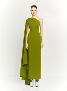 a woman wearing a green dress with one shoulder draped over her shoulders and the other in an asymmetrical style