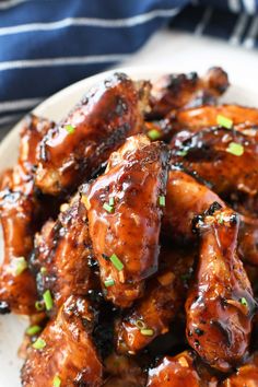 sweet and sticky apricot glazed chicken wings on a white plate with text overlay