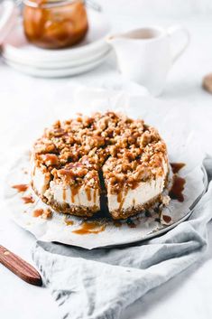 a cheesecake on a white plate with caramel drizzled around it