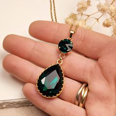 This exceptionally crafted crystal teardrop necklace is made of 14k gold plated brass components and 14k gold plated stainless steel chain, and the beautiful pronged Aurora fine crystals are incredibly luminous and brilliant! You can choose between four colors: - Emerald Green - Blue Sapphire - Ruby Red - Black Wendy never removes her pendant due to her curse. The pendant was originally blue when she was Immortal, then turned green after the Nine Lives curse. When used up eight of her lives, the stones changed color from green to red. When Wendy sacrificed her last life, her necklace turned black.  A beautiful piece for all Wendy's fans! DETAILS: - color: gold, green, red, black, blue - material: 14k gold plated stainless steel, 14k gold plated brass, Aurora fine crystals - pendant size: 5 Gold Crystal Teardrop Pendant Necklace, Gold Emerald Drop Necklaces, Gold Teardrop Crystal Necklaces With Adjustable Chain, Gold Teardrop Crystal Necklace With Adjustable Chain, Gold Drop Crystal Necklace As Gift, Gold Teardrop Crystal Drop Necklace, Gold Drop Crystal Necklace For Gift, Gold Drop Necklace With May Birthstone, Gold Drop Necklace With May Birthstone For Gift