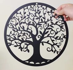 a person is drawing a tree on the wall