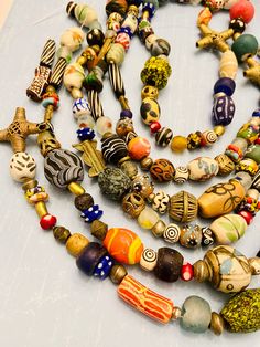 You will receive:   Assorted ethnic African & global beads. Random shapes and size-Mix rainbow colors recycled glass, ceramic, beads, African Brass, Bone beads. Cause they are totally handmade they are not perfect on shape and colors Please see all the pictures Beads are mixed RANDOMLY in no pattern. No two strands are exactly the same. amazing handmade beads, you'll love them! Material: Glass, Brass, Bone, resin Size: from 2-50mm Approximately   hole: 1-3mm Sold by strand 14" each Approximately Artisan Beaded Necklaces For Festivals, Multicolor Recycled Glass Bead Jewelry, Multicolor Recycled Glass Beaded Jewelry, Artisan Large Recycled Glass Beads, Artisan Multicolor Oval Beaded Necklaces, Artisan Multicolor Oval Beads Necklace, Artisan Beaded Necklaces With Recycled Glass Large Beads, Assorted Bohemian Jewelry For Festivals, Bohemian Assorted Jewelry For Festivals