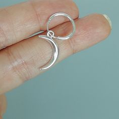 A PAIR of sterling silver 14mm hoops. Comes with a detachable and crescent moon charm. The charm is multipurpose and can be used with a neck or bracelet chain too. Dimension: Hoop- 1.5 x 14 mm Charm-10 x 16.5 mm Drop length- 30 mm Weight: 2.3gm Price is for ONE PAIR. These earrings are made of 925 hypoallergenic sterling silver. Most of my pieces come with a 925 stamp. Can be packaged in a gift box. I can include a personal message from you if needed You are welcome to contact me at... bhavnakwi Crescent Sterling Silver Cartilage Earrings As Gift, Silver Crescent Single Cartilage Earring, Silver Cartilage Earrings With Moon Charm As Gift, Silver Moon Charm Earrings For Everyday, Everyday Silver Earrings With Moon Charm, Silver Celestial Hoop Earrings For Everyday, Sterling Silver Crescent Hoop Earrings In Celestial Style, Celestial Style Small Hoop Sterling Silver Jewelry, Silver Crescent Hoop Earrings In Celestial Style