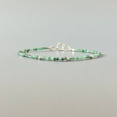 "Fall in love with our dainty emerald gemstone beaded bracelet, perfect timeless delicate minimalist design, designed to be stacked or worn on its own. Will make a thoughtful birthday, christmas. anniversary gift for your wife, mother, sister, daughter, or friend. Emerald is May birthstone- a prefect gift for someone born in May under Taurus zodiac sign. Also, perfect 20th wedding anniversary gift. Your purchase will arrive elegantly packed  in a gift-ready suede storage bag  and will include a Green Bracelets With Tiny Beads For Everyday, Everyday Green Bracelets With Tiny Beads, Green Everyday Bracelets With Tiny Beads, Elegant Green Beaded Bracelets With Tiny Beads, Dainty Green Beaded Bracelets For Everyday, Minimalist Green Beaded Bracelets With Tiny Beads, Minimalist Green Beaded Bracelet With Tiny Beads, Minimalist Green Beaded Bracelet For Everyday, Adjustable Minimalist Beaded Bracelets For May Birthstone