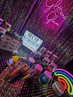 there are many items on the table with neon lights in the backgroung