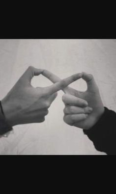 two hands making a heart shape with their fingers