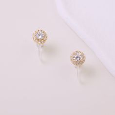 These diamond clip-on studs boast a classic design with classic shapes and cuts to impart timeless elegance. Crafted with zirconia, they make for a magnificent addition. 18k gold-plated with CZ stones SIZE & WEIGHT 7mm long approx. 0.5g per earring approx. No piercings required Sold as a pair Features our signature resin clip for a snug but comfortable fit on your lobe Cz Stone, No Se, Clip On Earrings, Round Diamonds, Classic Design, Timeless Elegance, Gold Earrings, Piercings, 18k Gold