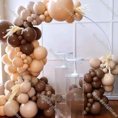 a bunch of balloons that are in the shape of an arch on a wooden floor