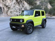 a bright yellow jeep is parked on the side of the road