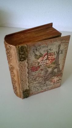 an old book with the eiffel tower painted on it