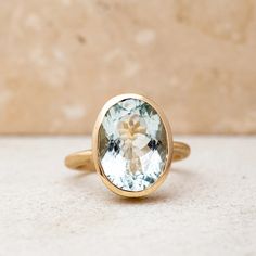 A handmade cassin jewelry piece featuring a large oval aquamarine stone set in yellow gold. Oval Aquamarine Ring, Aquamarine Gold Ring, Oval Stone Ring, Blue Aquamarine Ring, Treasure Jewelry, Blue Emerald, Aquamarine Ring, March Birthstone, Aquamarine Stone