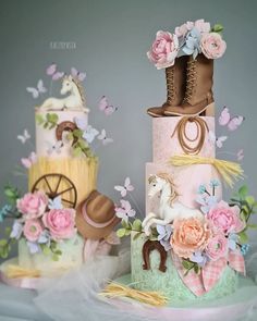 three tiered cakes decorated with horses and flowers on top of each other in pastel colors