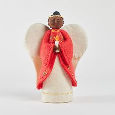 an angel figurine with red and white wings