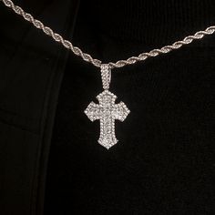 Introducing the Diamond Gothic Cross Pendant in 14k White Gold. This exclusive piece is fully iced out with hand-set stones in a detailed gothic cross design that will instantly elevate your look. Perfect for any occasion, this cross is a timeless symbol of faith and style. Pair it with the 4mm Rope Chain for a set that is guaranteed to turn heads! This product is guaranteed for life - GLD will repair the item should you experience any defects in craftsmanship or breakage. Specifications - 25mm Iced Out White Gold Cross Pendant Jewelry, Iced Out Diamond Cross Jewelry, Silver Iced Out Cross Pendant Necklace, Iced Out Diamond Cross Pendant Jewelry, White Gold Bling Cross Jewelry, Iced Out Diamond White Cross Jewelry, Diamond Cross Pendant Jewelry With Bling, Cross Shaped Crystal Jewelry With Diamond Accents, Cross-shaped Diamond Jewelry With Rhinestones