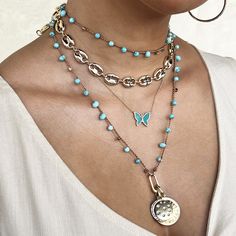 Double Disc CZ Charms On Faux Turquoise Bead Braided String Necklace Add a pop of color to any outfit with our Turquoise Charm Necklace. This beaded necklace is adorned with playful charms that will add a fun touch to your style. Perfect for any occasion, this necklace will bring a touch of whimsy to your wardrobe. Yellow Gold Plated Sunburst Charm: 0.97" Wide Moon & Star Charm: 0.77" Wide 32" Long Butterfly Chain Necklace, Diamond Charm Necklace, Jennifer Miller, Dagger Necklace, Turquoise Butterfly, Moonstone Drop Earrings, Butterfly Chain, String Necklace, Diamond Ear Cuff