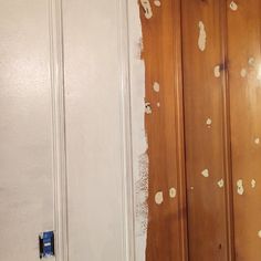 a room with white walls and wood paneling that has been stripped off from the wall