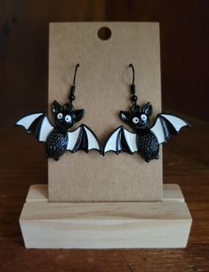 Handmade earrings with cute enamel Halloween charm.  Double backings automatically included. Black Hypoallergenic Halloween Earrings, Black Hypoallergenic Earrings For Halloween, Themed Black Dangle Jewelry, Nickel-free Black Spooky Earrings, Black Novelty Drop Earrings, Themed Black Dangle Earrings, Gothic White Dangle Jewelry, White Gothic Dangle Jewelry, Cute Black Pierced Jewelry