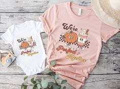 "Get ready for a fall celebration with our delightful Matching Mommy and Me Pumpkin Spice T-Shirts! Designed to capture the joy and flavor of the season, these t-shirts proudly say \"We're a Perfect Match\" in a retro groovy font, and showcase the charming graphic of a pumpkin and pumpkin spice latte as retro mascot characters. These Mommy And Me Shirts are the perfect way to embrace the Fall spirit with style and a sprinkle of fun. Ideal for a family Halloween event or a Thanksgiving gathering, these Pumpkin Spice Shirt options will make you and your little one the talk of the town. Crafted with love and a passion for Pumpkin Spice Latte, these t-shirts are more than just a fashion statement; they're a celebration of the bond between mom and child. They make a wonderful Mom And Son or Mom Family Matching Pink Tops For Fall, Graphic Print Tops For Birthday In Fall, Cute Fall Birthday Tops, Retro Groovy Font, Retro Mascot, Mom And Baby Outfits, Thanksgiving Gathering, Mommy And Me Shirts, Love Twins