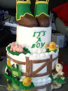 a birthday cake decorated with farm animals and boots