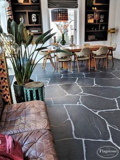 a living room filled with furniture and a stone floor