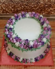 there is a cake decorated with purple and white flowers