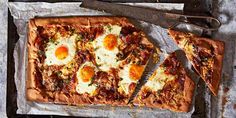 two slices of pizza sitting on top of a pan next to a spatula and knife